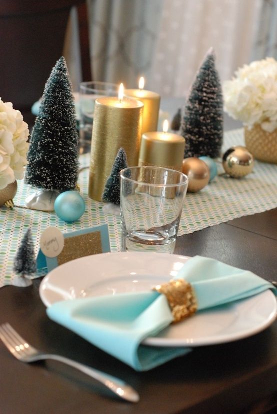 décoration-table-Noël-serviettes-bleu-clair-rond-doré-petits-sapins-Noel-verts-bougies-dorées