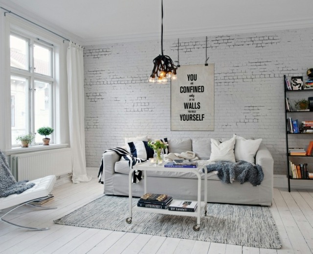 salon design moderne lampe suspendue design canapé blanc tapis de sol table basse de salon rideaux blancs