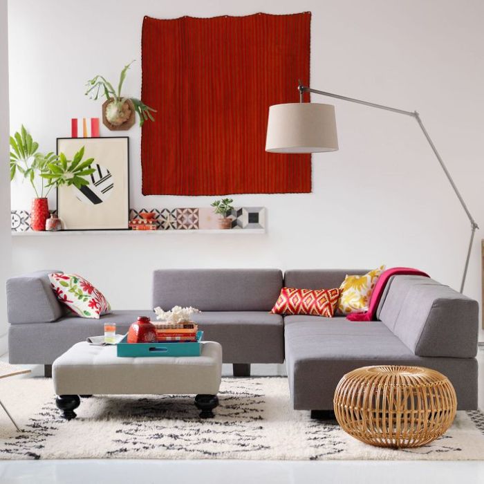 intérieur salon moderne tableau rouge canapé gris tabouret  pouf plateau de table bleu plante lampe moderne et design