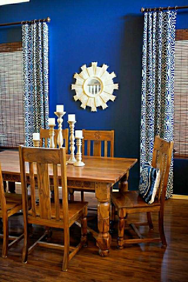 séjour murs couleur indigo intérieur moderne table de salon en bois chaise design déco bougies rideaux