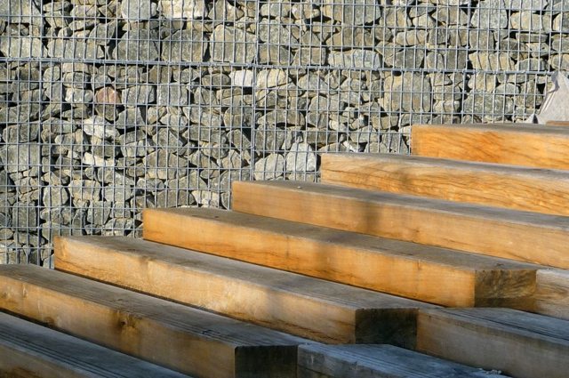escalier bois contraste avec mur en pierres