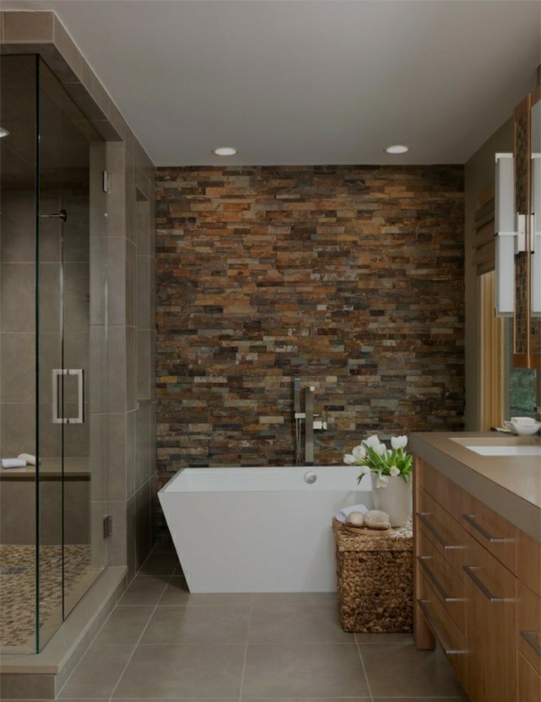 salle de bain tendance moderne mur briquettes pierre baignoire idée aménagement déco fleurs 