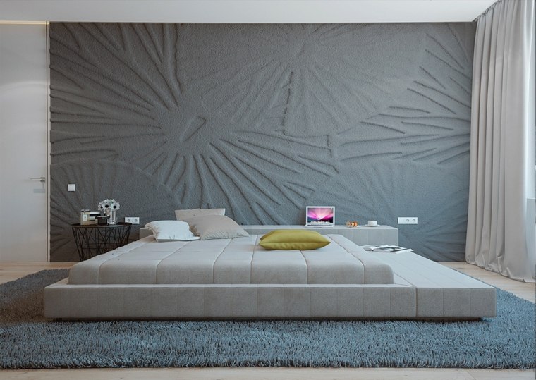 intérieur chambre à coucher idée aménagement grand lit coussins papier peint gris effet 3D tapis de sol moelleux