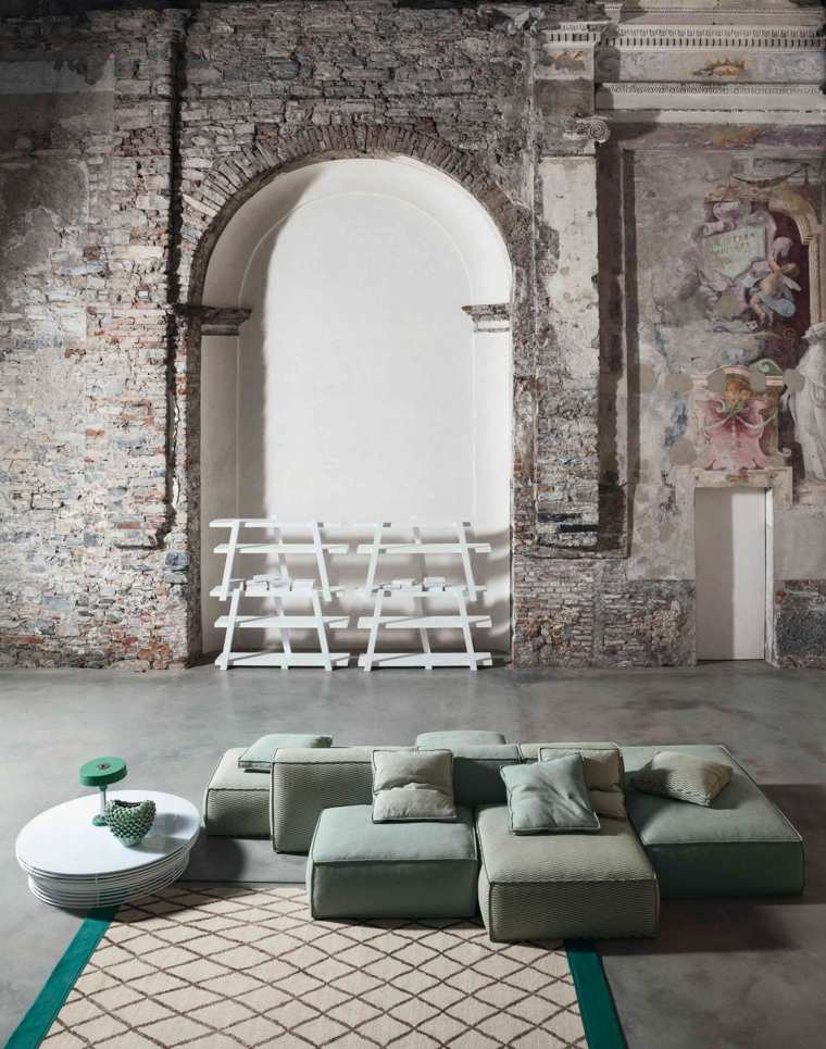 canapé composable moderne idée salon aménagement mur pierre table basse tapis motif graphique