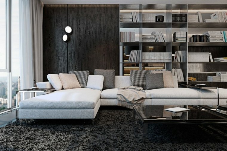 appartement de luxe salon design canapé d'angle coussins tapis de sol bibliothèque luminaire table basse noire