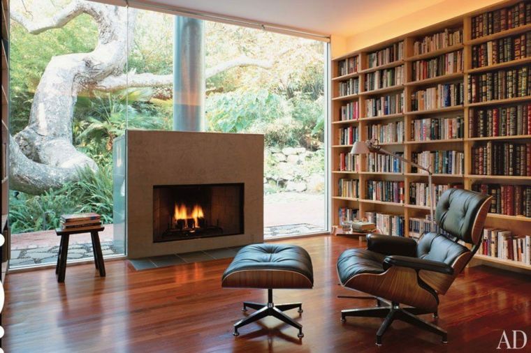 intérieur design aménager idée bibliothèque bois fauteuil cheminée intérieur