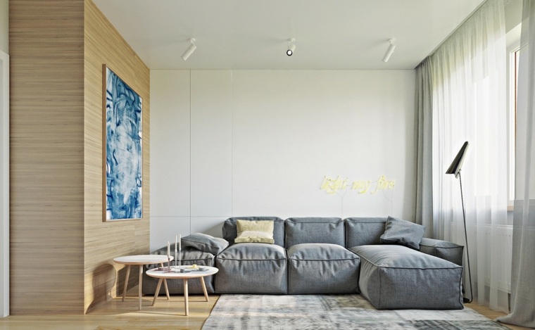 intérieur design tendance canapé gris coussins tapis sol tableau mur table basse bois