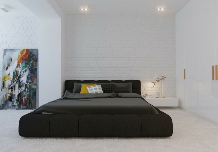 lit au sol chambre à coucher design tableau adossé mur en briques