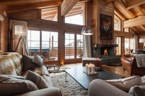 chalet luxe cabine chasse montagne interieur bois chaleureux cheminee fauteuil cuir